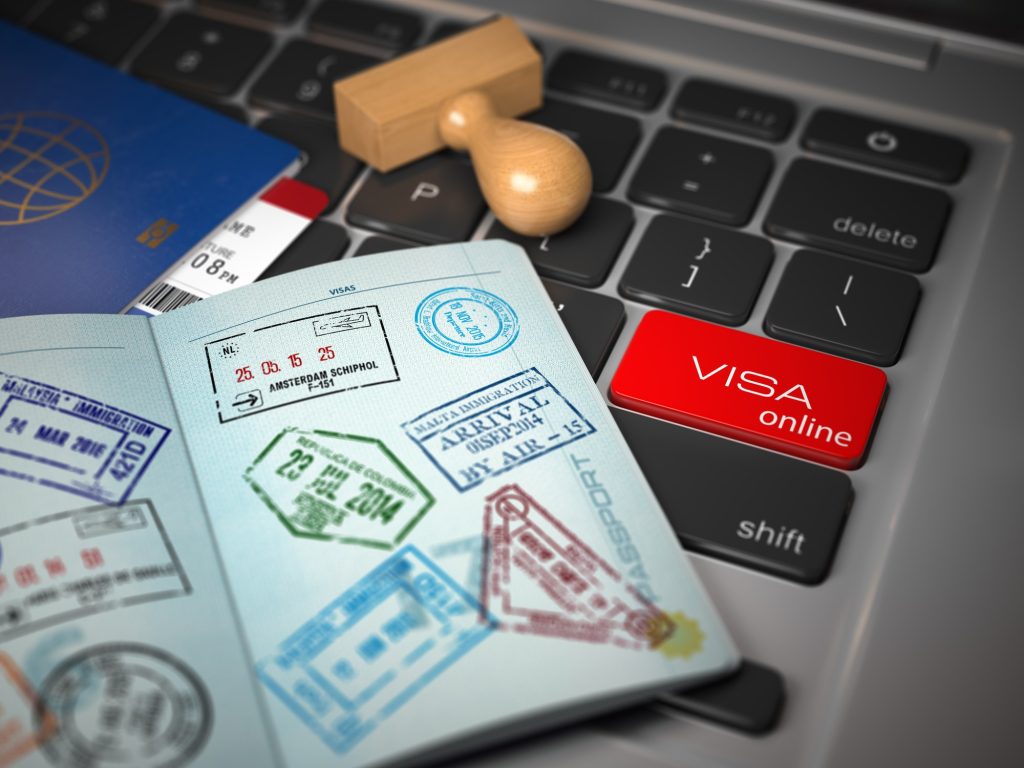 visa-online-application-concept-open-passport-with-visa-stamps